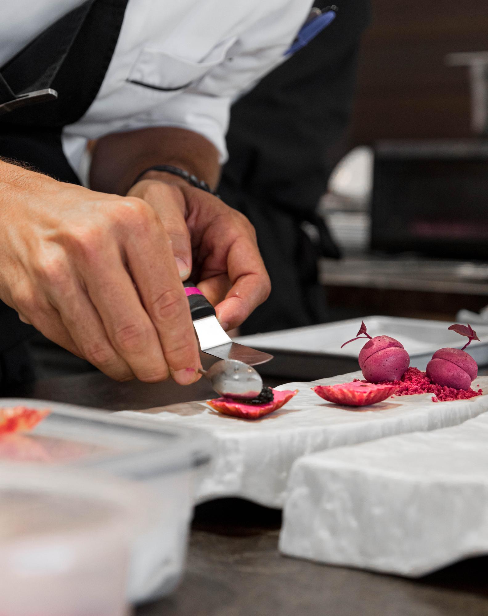 chef hands finishing garnish